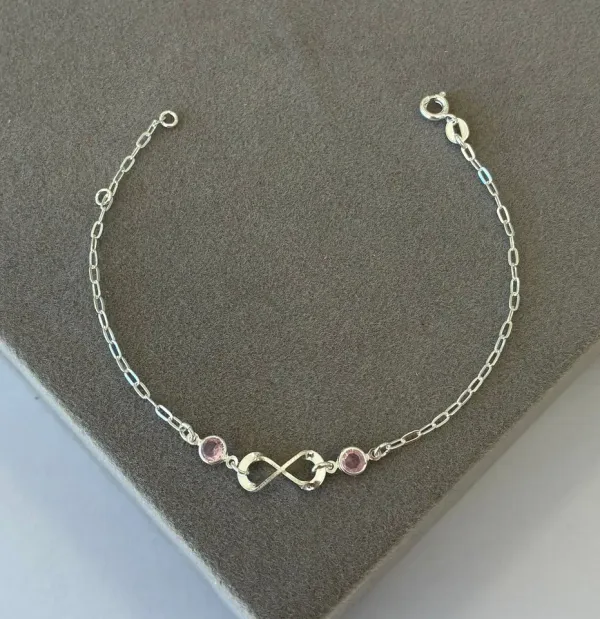 Pulseira cartier infinito e pontos de luz rosa claro
